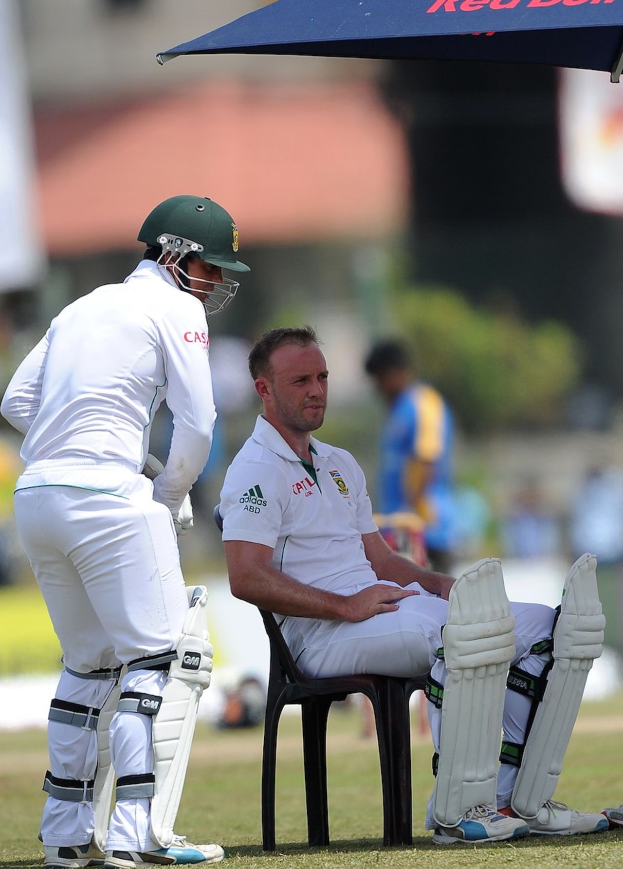 AB de Villiers takes a breather during the drinks break while Quinton de Kock does some shadow practice, Sri Lanka v South Africa, 1st Test, Galle, 4th day, July 19, 2014