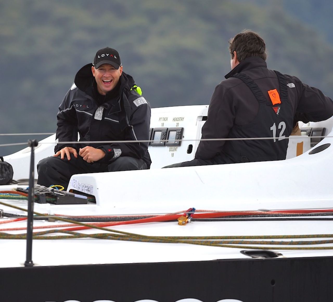 Michael Clarke chats to a fellow crew member onboard a racing yacht, Sydney, July 26, 2014