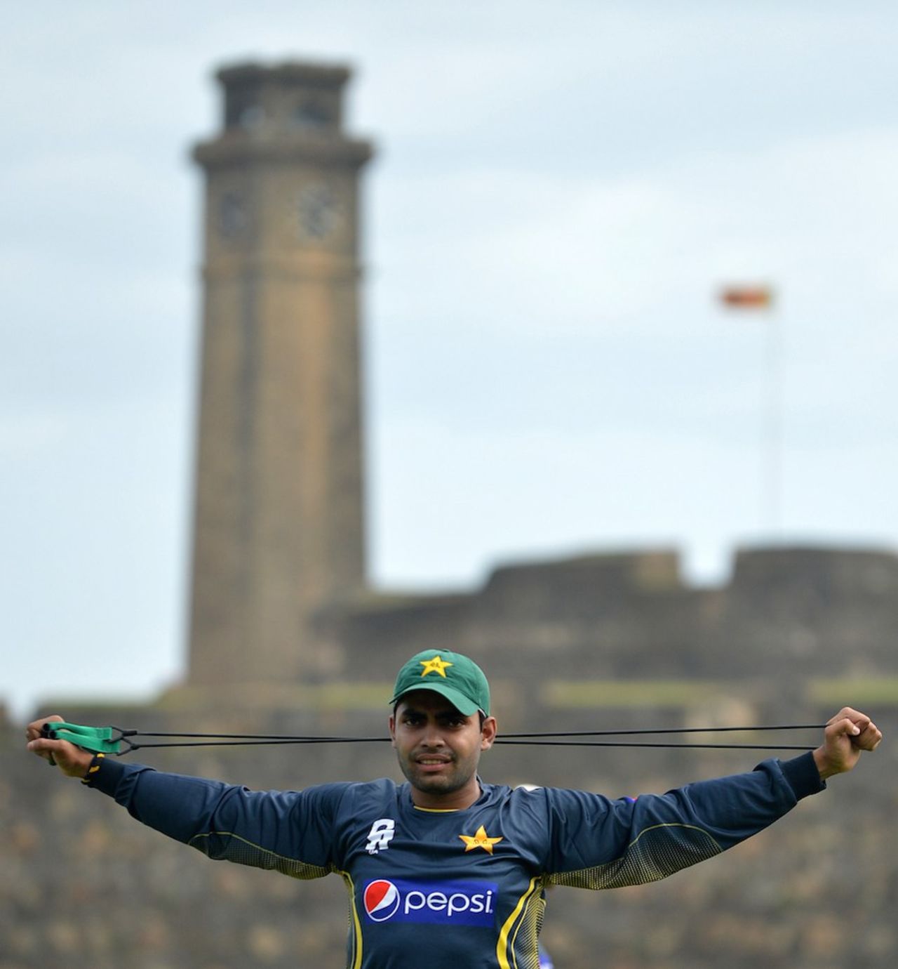 Umar Akmal stretches during a practice session, Galle, August 3, 2014
