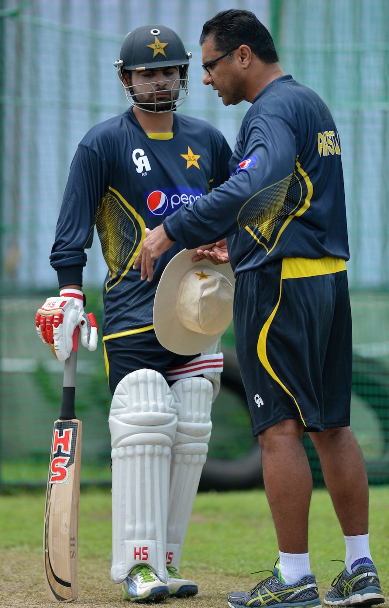 Ahmed Shehzad listens carefully in the presence of Waqar Younis, Galle, August 4, 2014