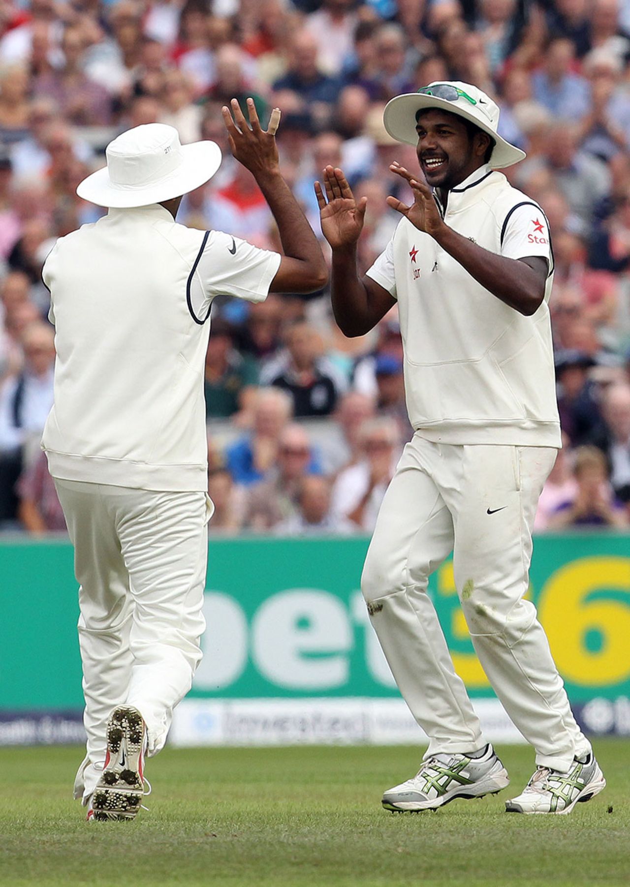 Varun Aaron is delighted after taking a smart catch at midwicket to dismiss Chris Jordan, England v India, 4th Test, Old Trafford, 2nd day, August 8, 2014