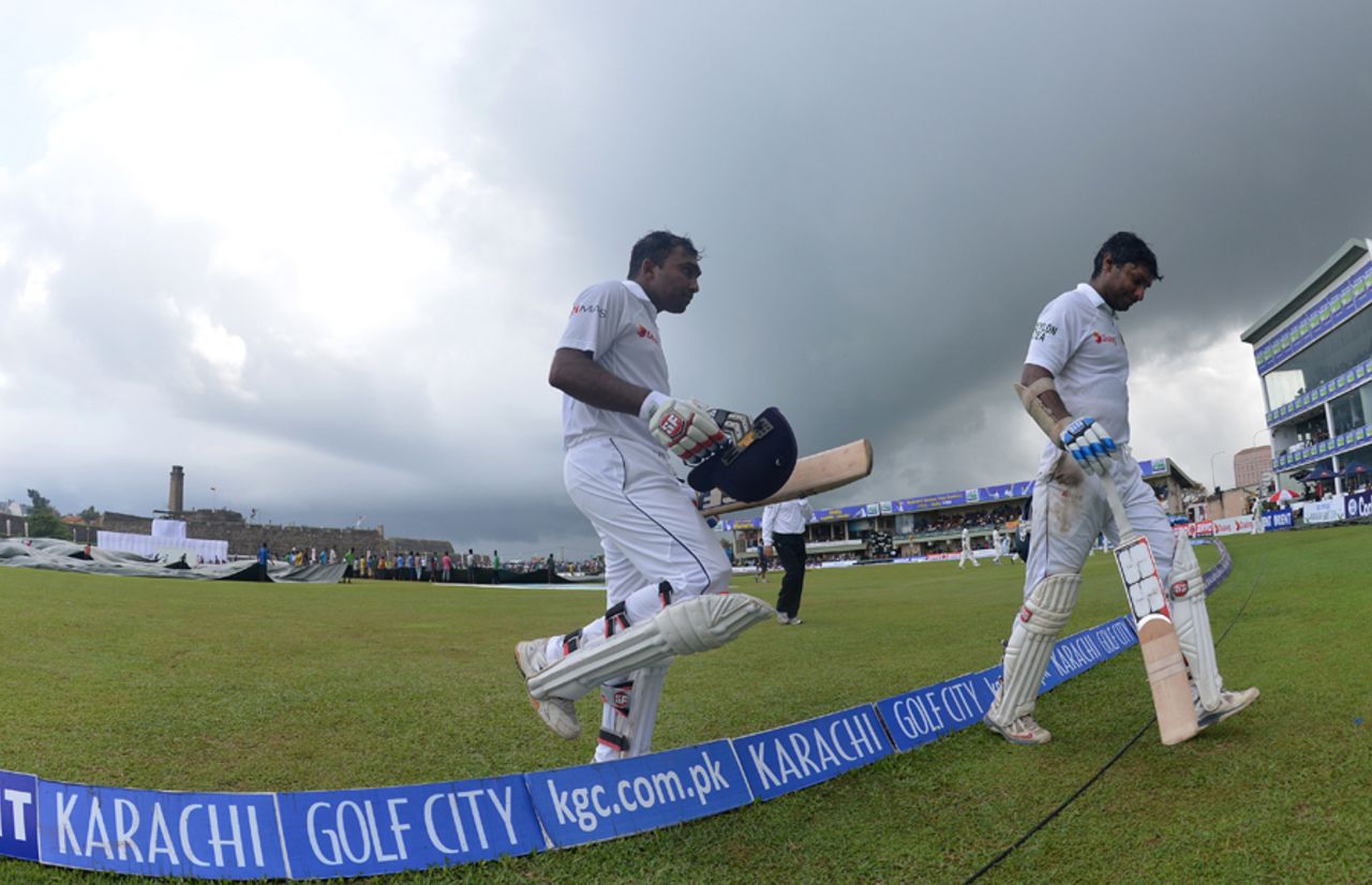 Mahela Jayawardene and Kumar Sangakkara walk off as the weather intervenes, Sri Lanka v Pakistan, 1st Test, Galle, 3rd day, August 8, 2014