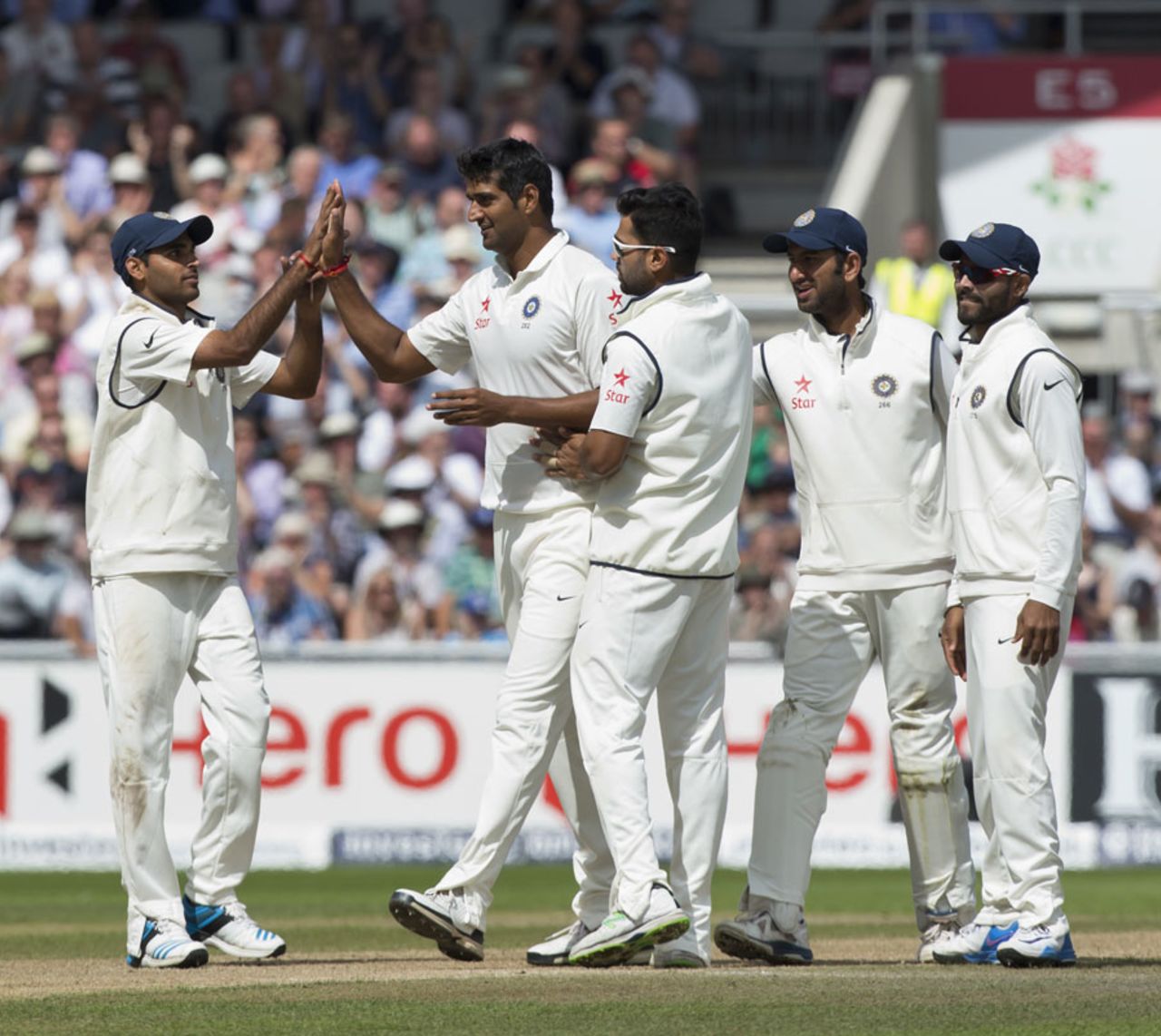 Pankaj Singh is congratulated after his first Test wicket, England v India, 4th Test, Old Trafford, 3rd day, August 9, 2014