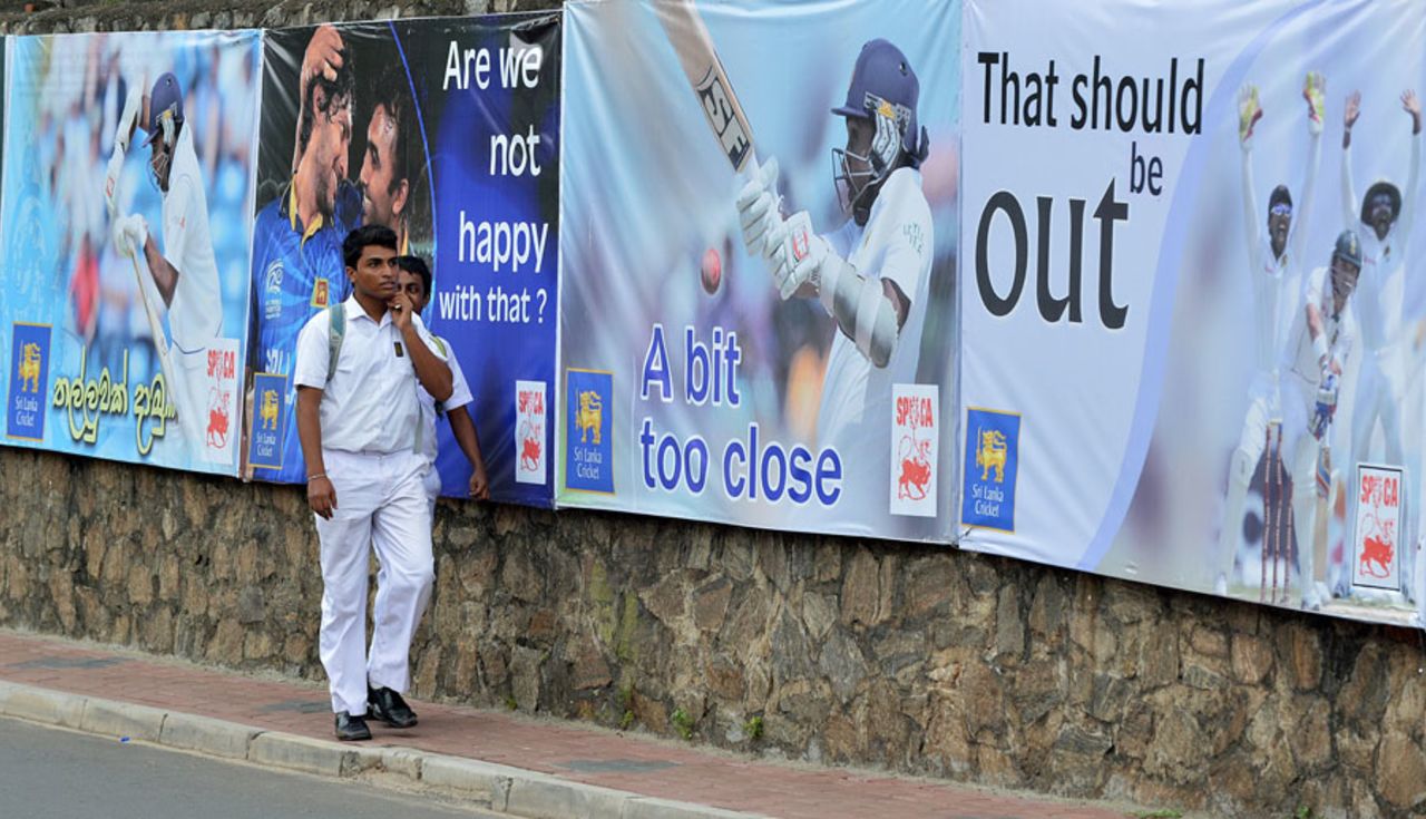 Schoolchildren walk past posters of Mahela Jayawardene outside SSC, Sri Lanka v Pakistan, 2nd Test, Colombo, 3rd day, August 16, 2014