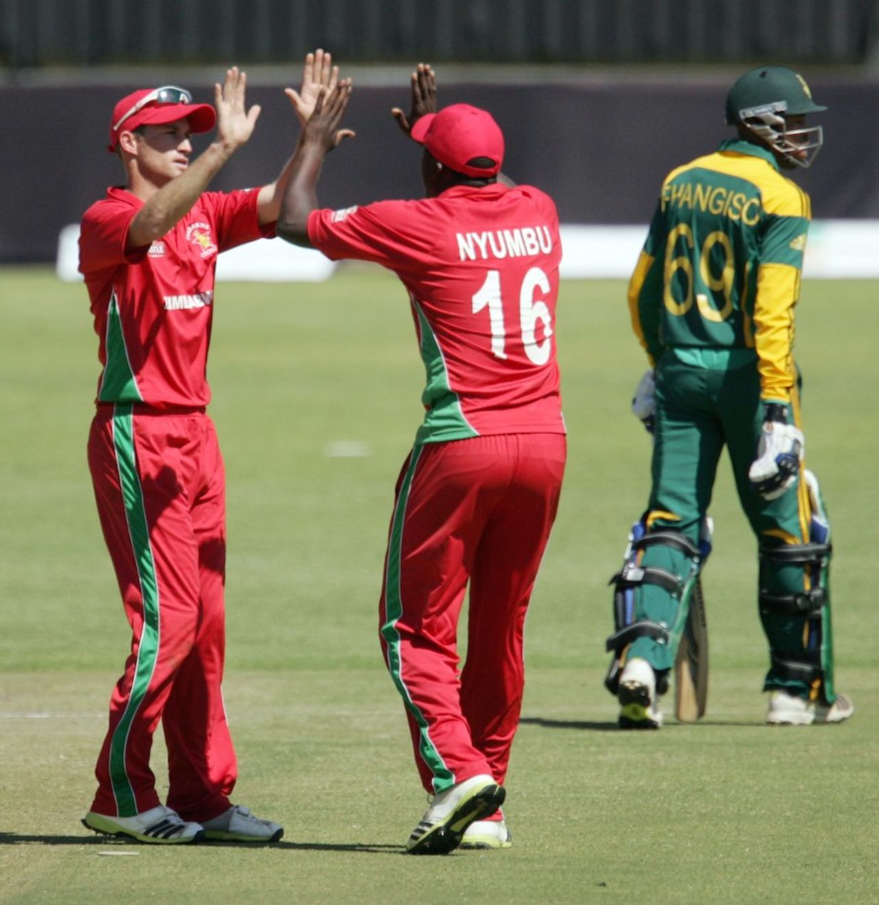 Sean Williams and John Nyumbu celebrate the dismissal of Aaron Phangiso, Zimbabwe v South Africa, 2nd ODI, Bulawayo, August 19, 2014