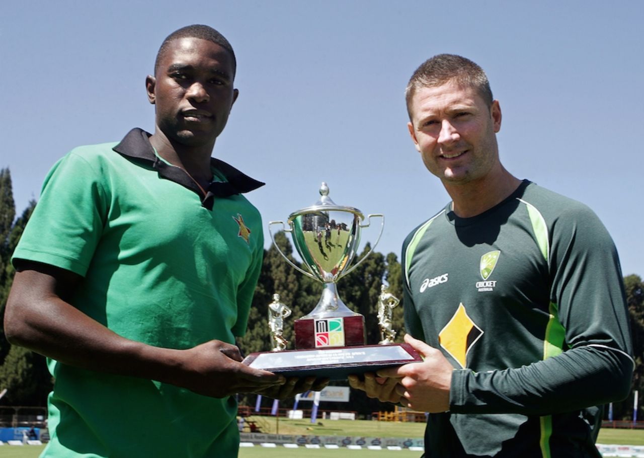Elton Chigumbura and Michael Clarke pose with the series trophy, Harare, August 24, 2014