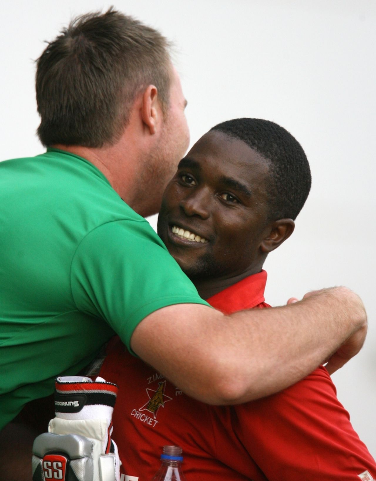 Brendon Taylor embraces Elton Chigumbura after the win, Zimbabwe v Australia, tri-series, Harare, August 31, 2014
