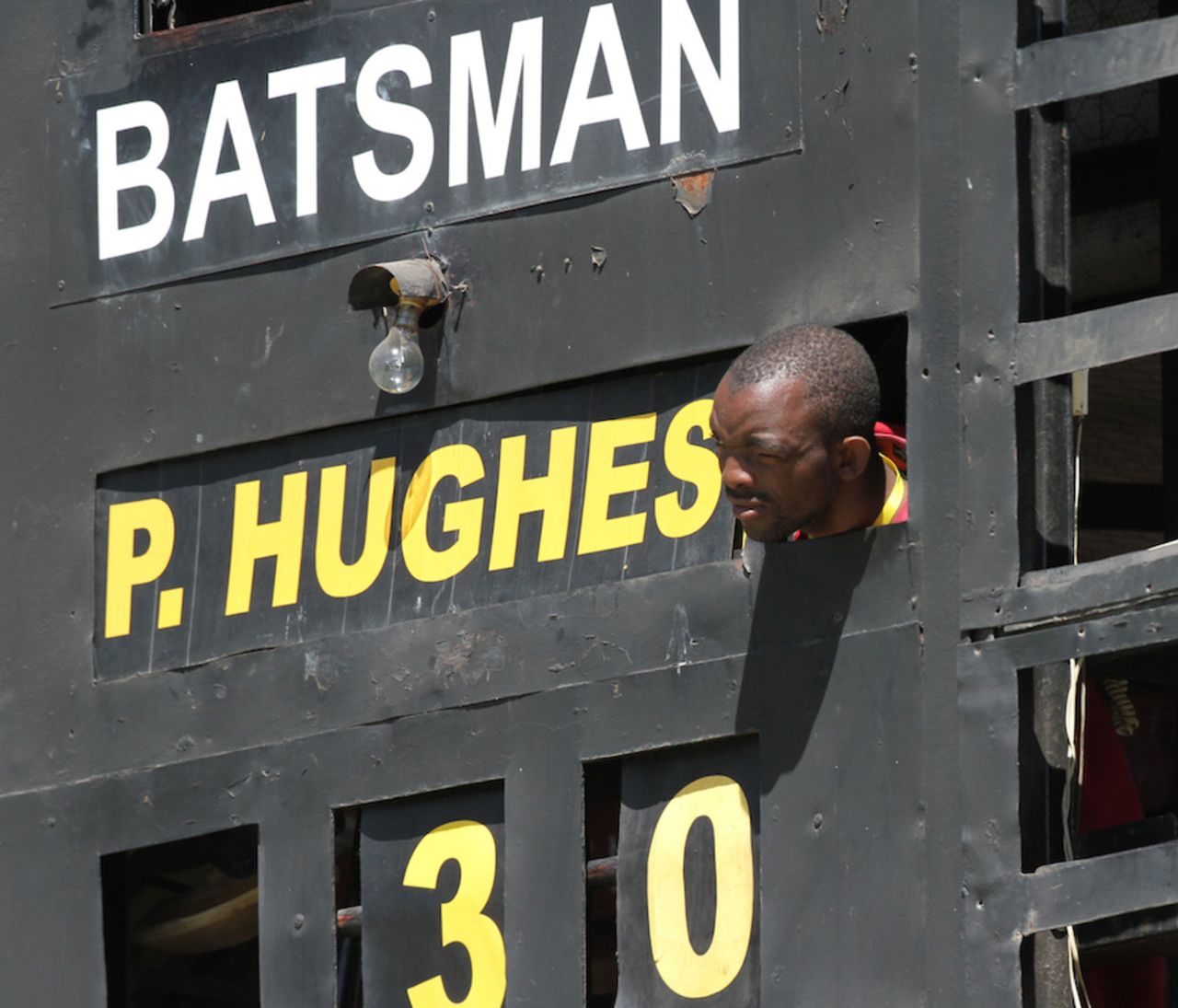 A scoreboard operator peeps out to catch some action, Australia v South Africa, tri-series, Harare, September 2, 2014