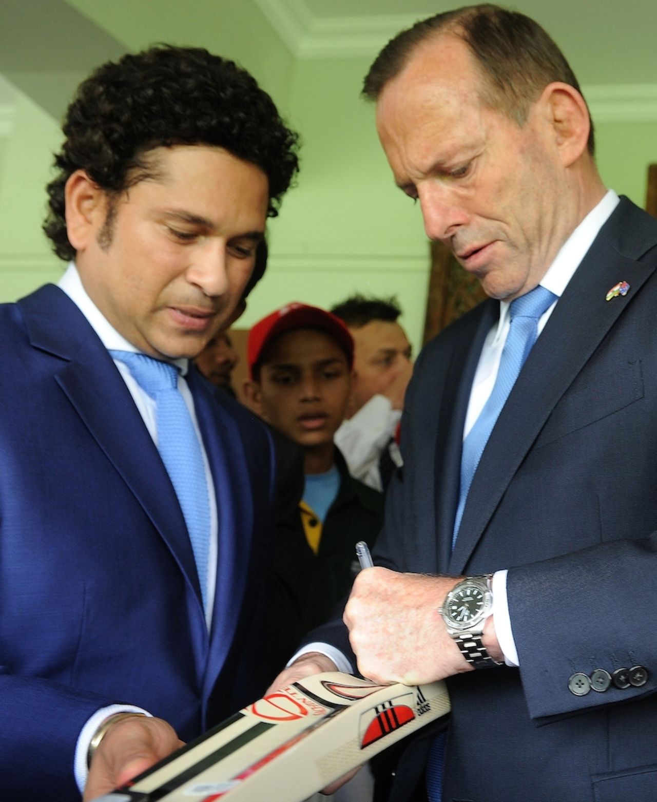 Cricket diplomacy: Sachin Tendulkar and Tony Abbott, Australia's prime minister, sign autographs, Mumbai, September 4, 2014