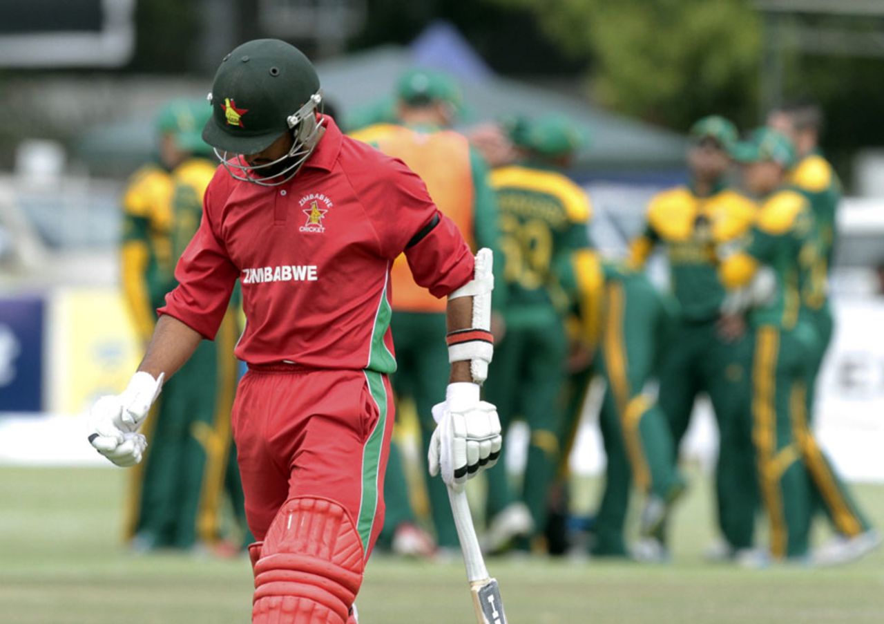 A disappointed Sikandar Raza heads back after holing out to point, Zimbabwe v South Africa, tri-series, Harare, September 4, 2014
