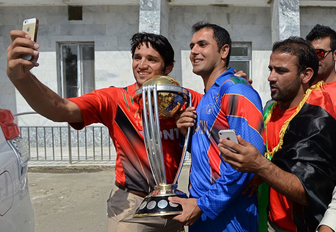 Fans grab the chance for a photo with Mohammad Nabi and the World Cup, Kabul, September 13, 2014