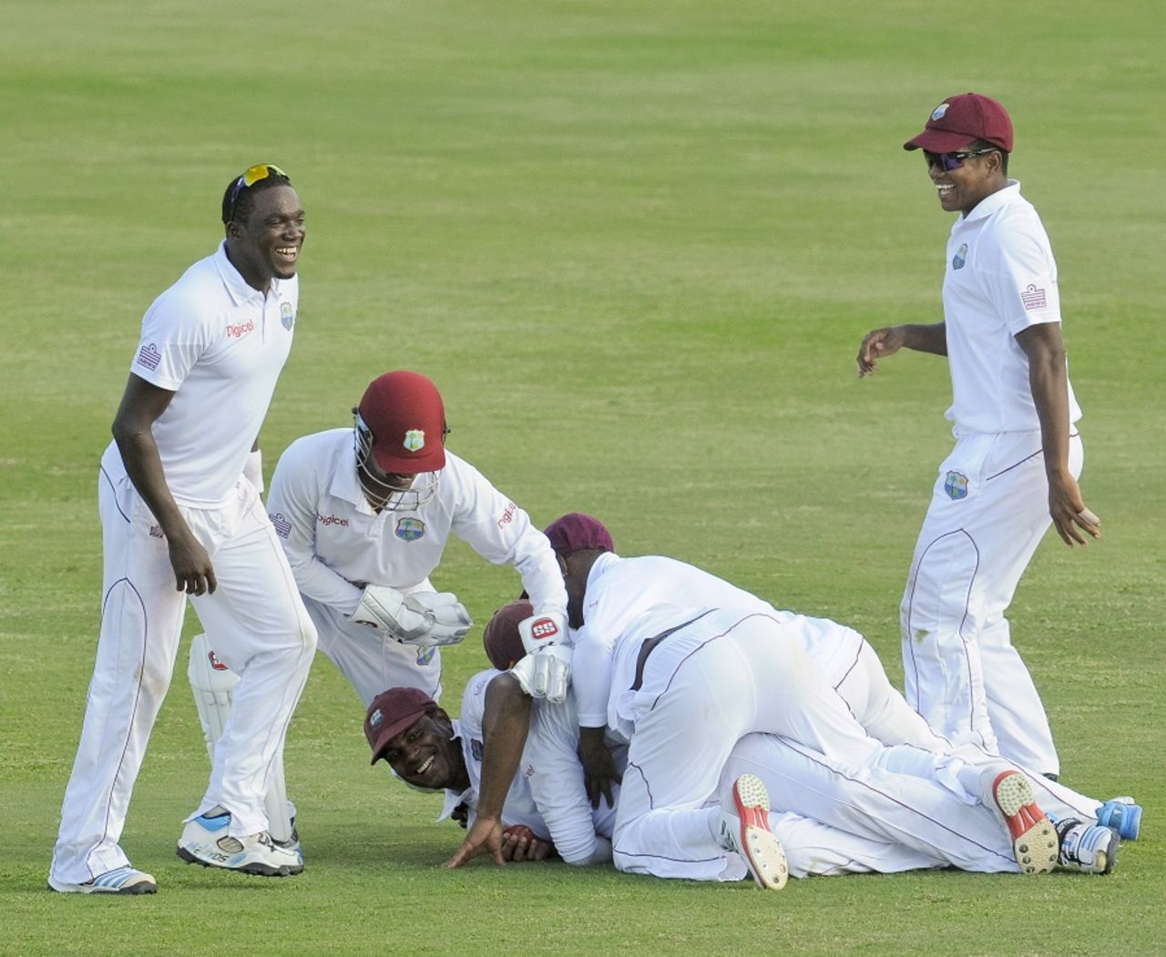 Shannon Gabriel's team-mates pile up on top of him after he took a catch, West Indies v Bangladesh, 2nd Test, St. Lucia, 4th day, September 16, 2014