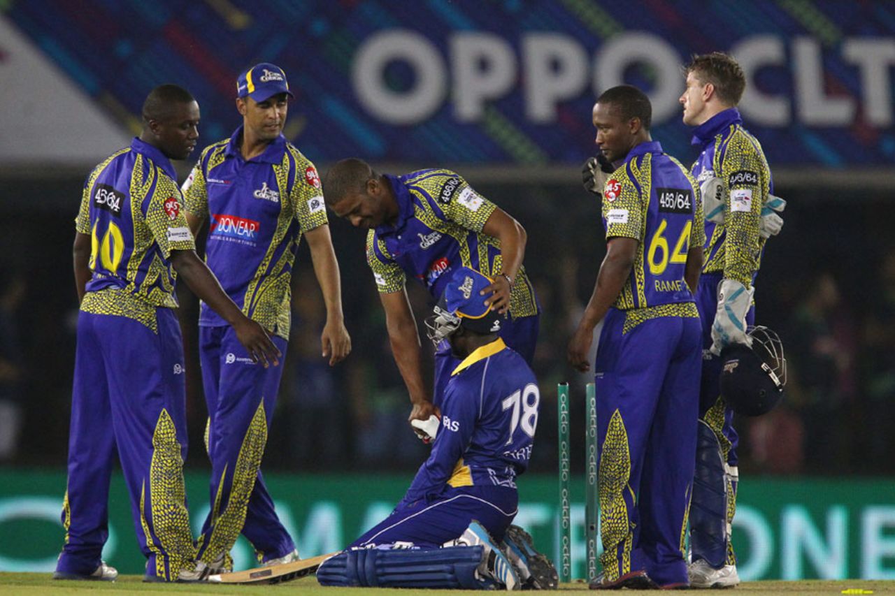 A distraught Jonathan Carter is consoled by the Cobras players, Barbados Tridents v Cape Cobras, Champions League T20, Group B, Mohali, September 26, 2014