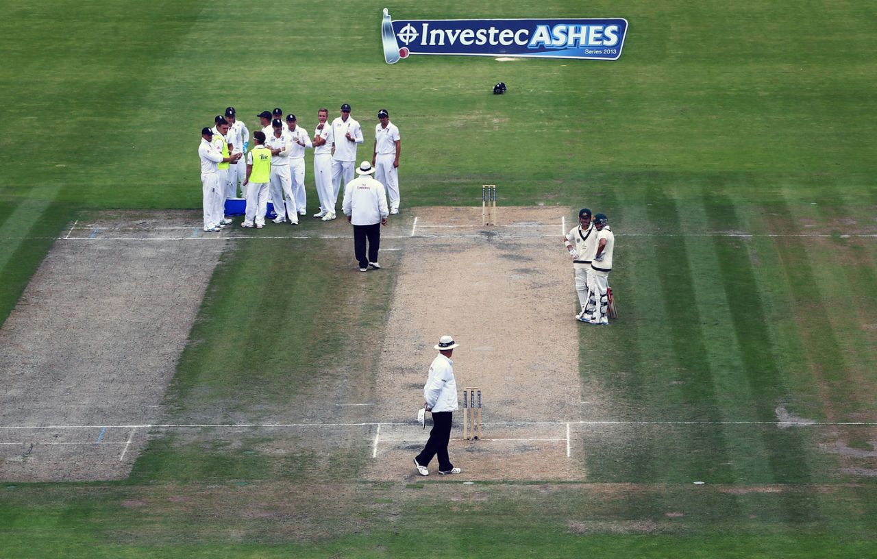 The England players wait for a review against David Warner England v Australia, 3rd Investec Test, Old Trafford, 4th day, August 4, 2013