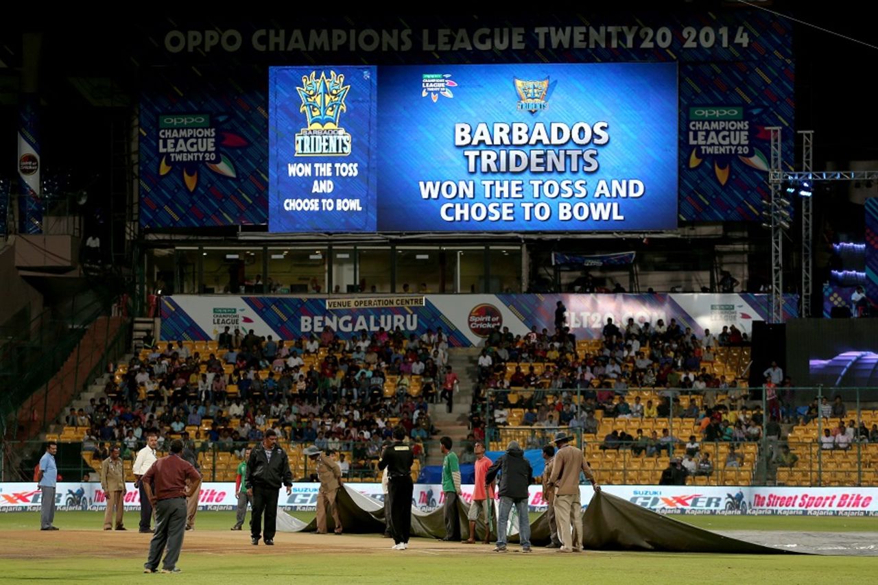 Covers come off after a brief drizzle before the start of the match, Barbados Tridents v Northern Districts, Champions League T20, Group B, Bangalore, September 30, 2014