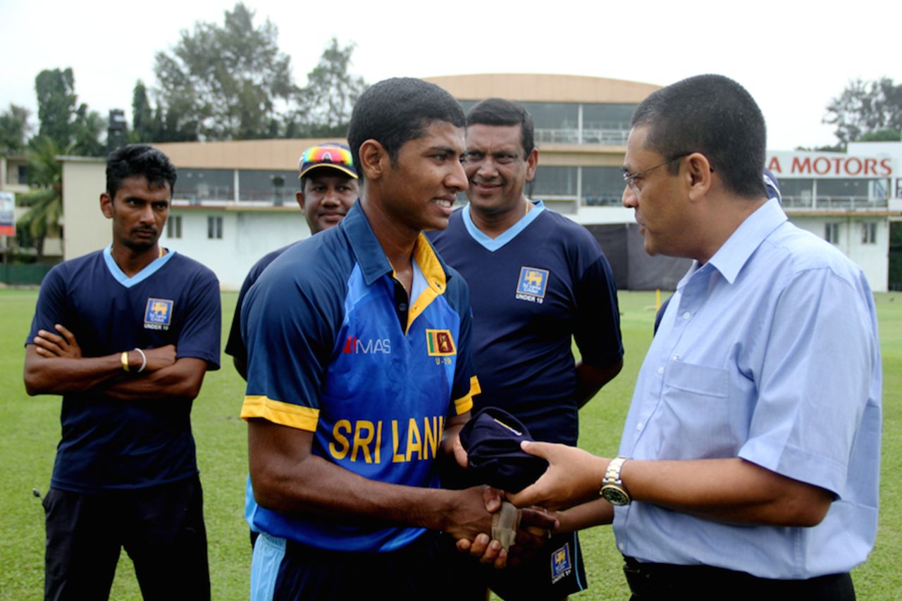Thiran Dhanapala gets his Under-19 cap from Ranjan Madugalle, Colombo, October 3, 2014