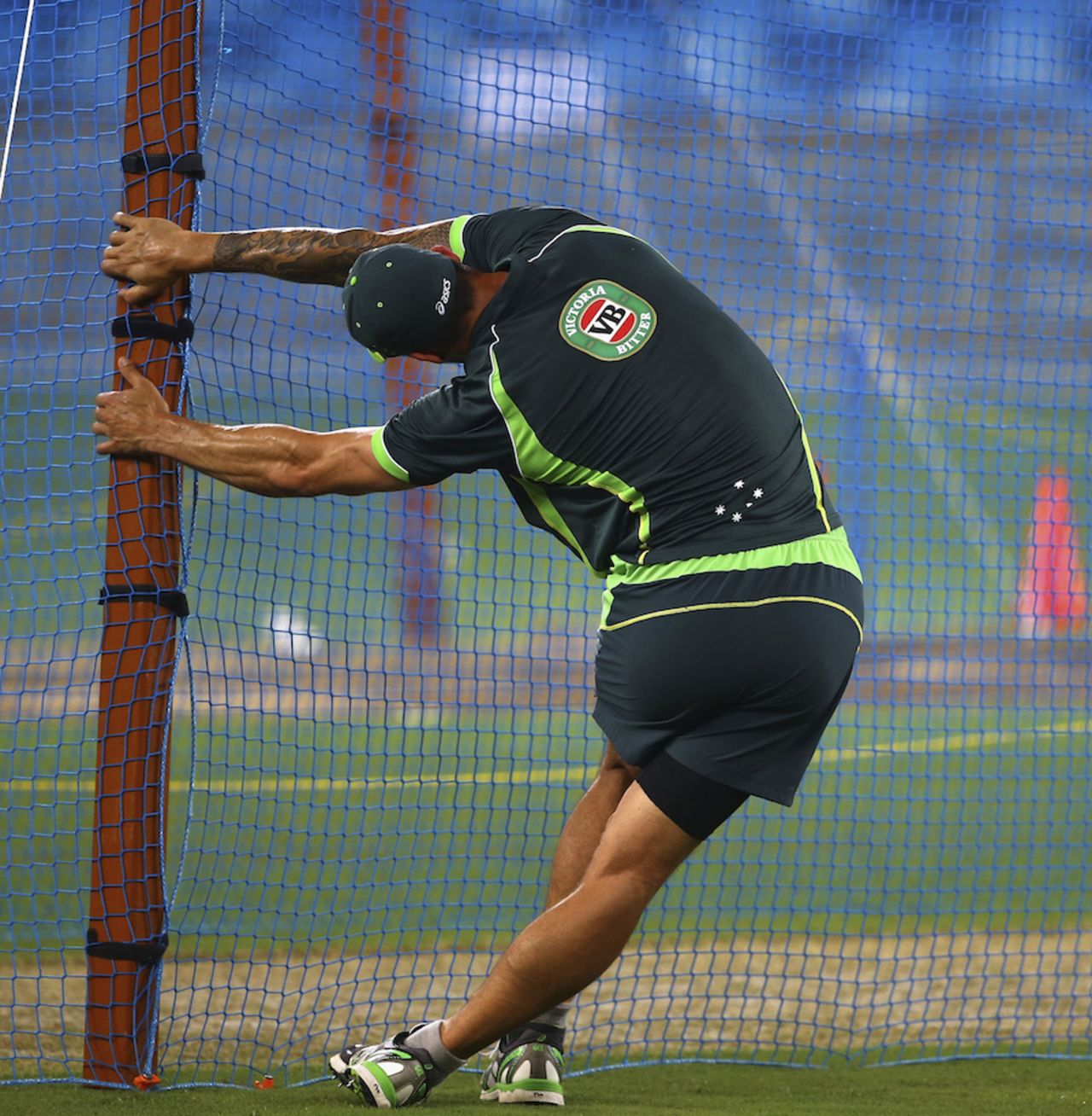 Mitchell Johnson stretches during a net session, Dubai, October 4, 2014