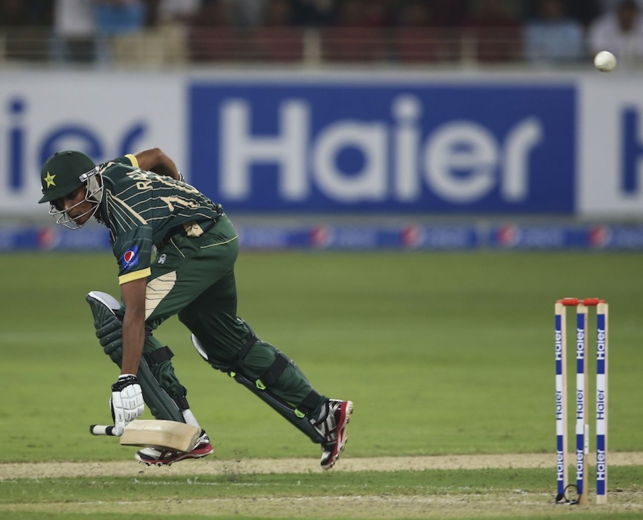 Raza Hasan loses the bat while completing a run, Pakistan v Australia, only T20I, Dubai, October 5, 2014