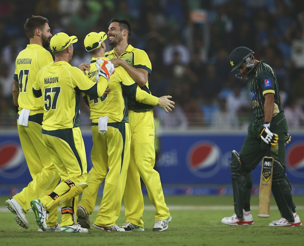 Mitchell Johnson is mobbed after he removed Shahid Afridi, Pakistan v Australia, 2nd ODI, Dubai, October 10, 2014