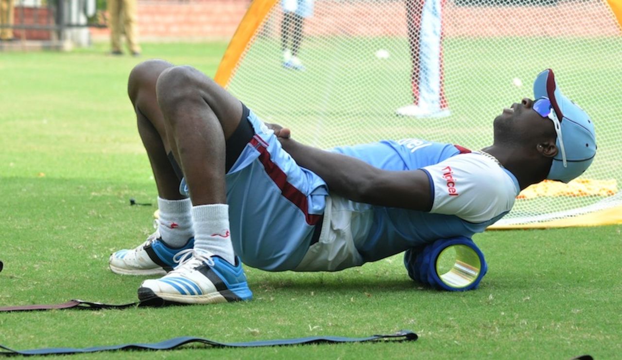 Kemar Roach stretches during a training session, Delhi, October 14, 2014