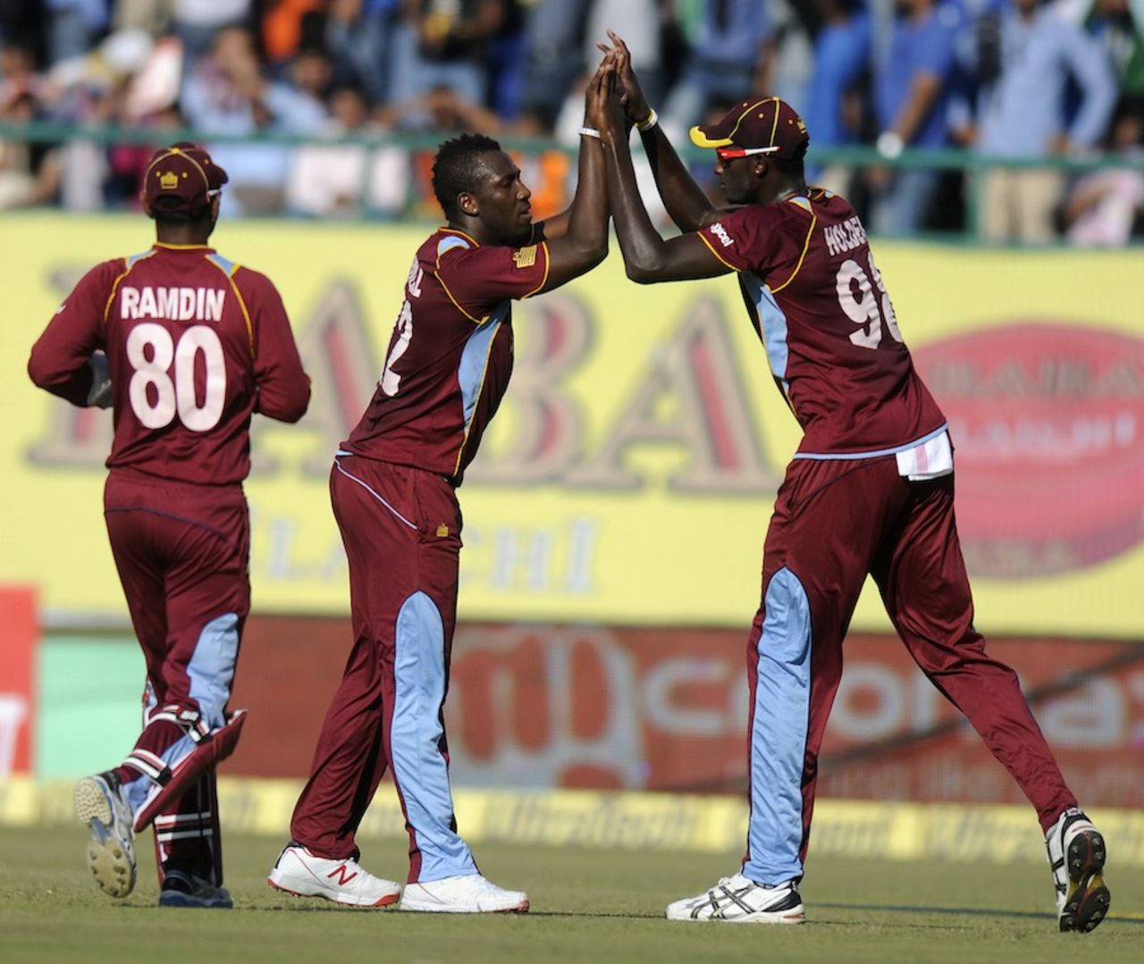 Andre Russell and Jason Holder celebrate a wicket, India v West Indies, 4th ODI, Dharamsala, October 17, 2014