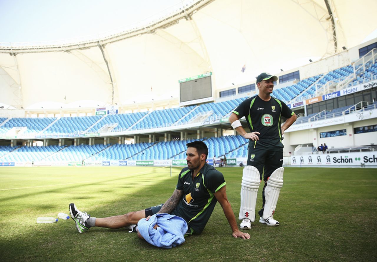 Mitchell Johnson and David Warner take a breather at training, Dubai, October 20, 2014