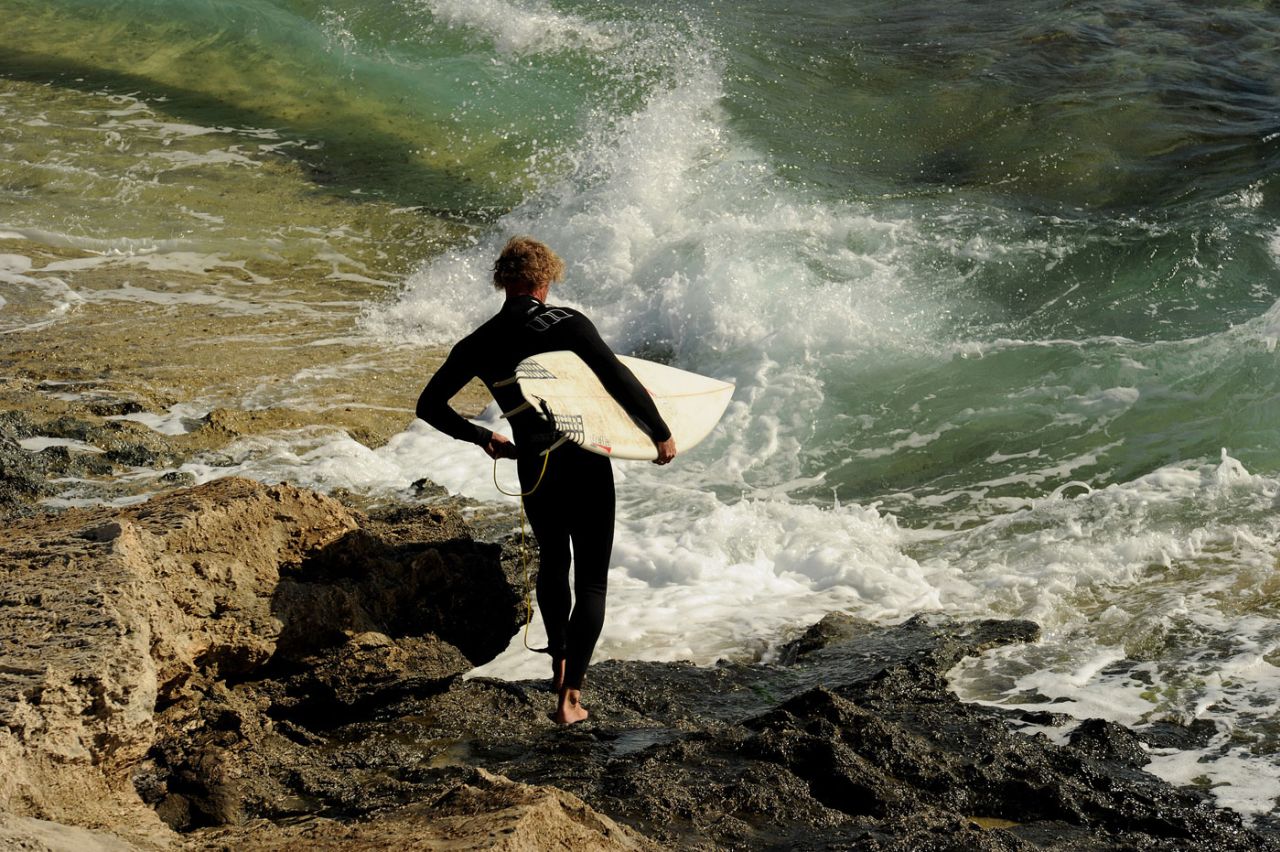 A surfboard rider prepares to enter the water at the Margaret River break in the world-renowned surfing area. May 11, 2011