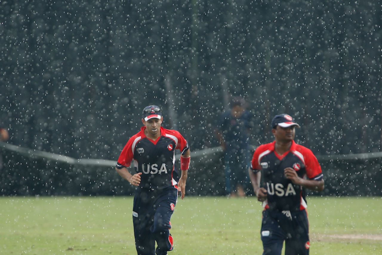 The USA players run back during a rain interruption, Nepal v USA, ICC WCL Division Three, Kuala Lumpur, October 28, 2014