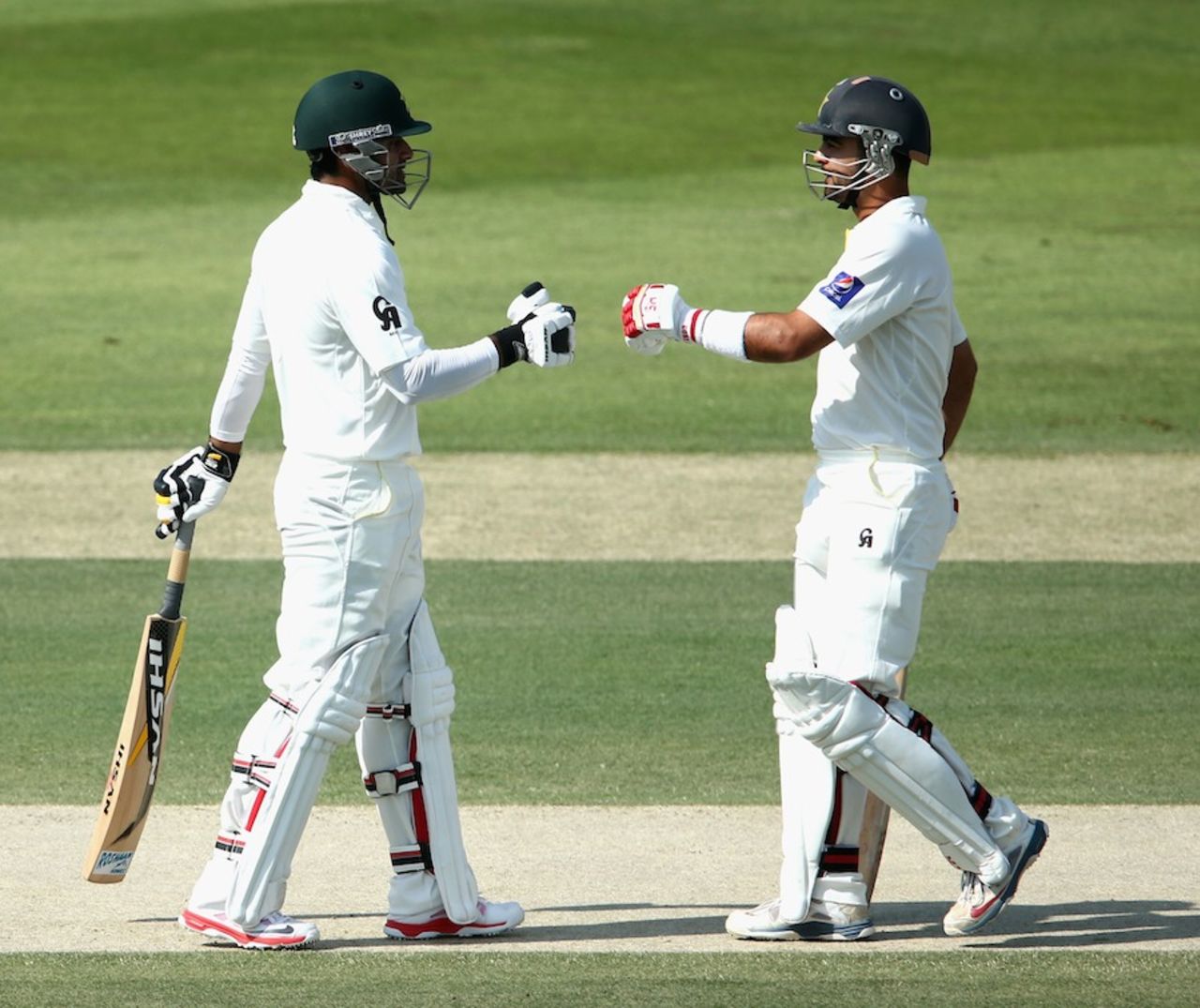Mohammad Hafeez and Ahmed Shehzad punch gloves, Pakistan v Australia, 2nd Test, Abu Dhabi, 1st day, October 30, 2014