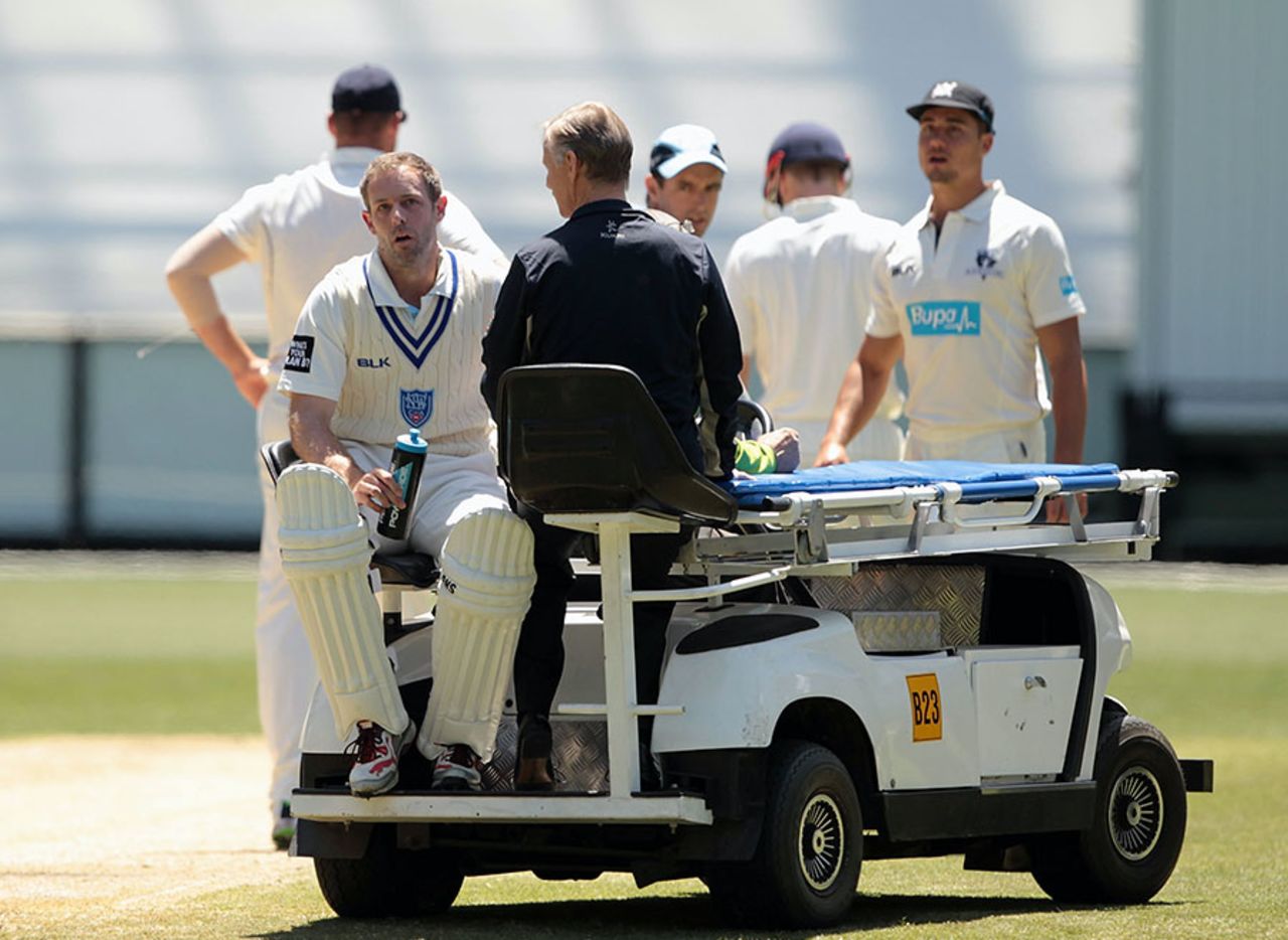 A motorised stretcher takes Ben Rohrer off the field after he was struck in the head by a bouncer, Victoria v NSW, Sheffield Shield 2014-15, Melbourne, 4th day, November 3, 2014