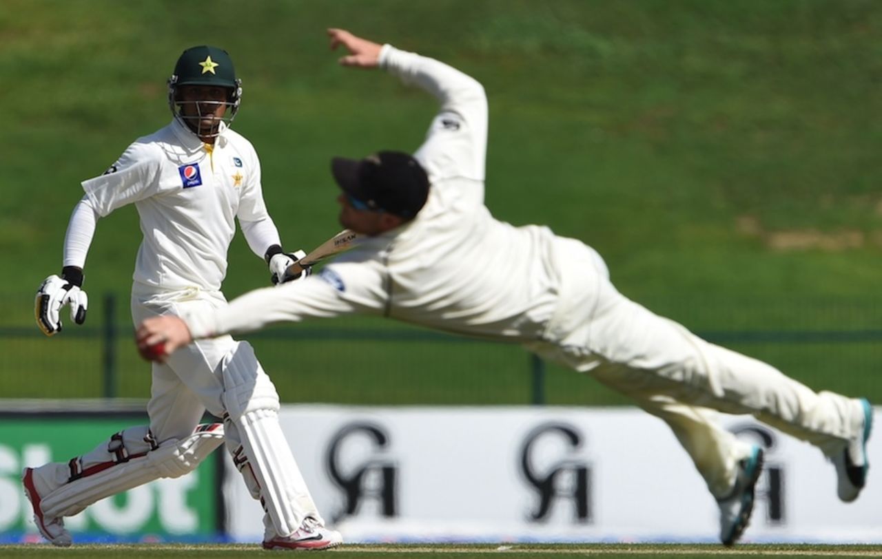Mohammad Hafeez watches Brendon McCullum make a diving stop, Pakistan v New Zealand, 1st Test, Abu Dhabi, 1st day, November 9, 2014
