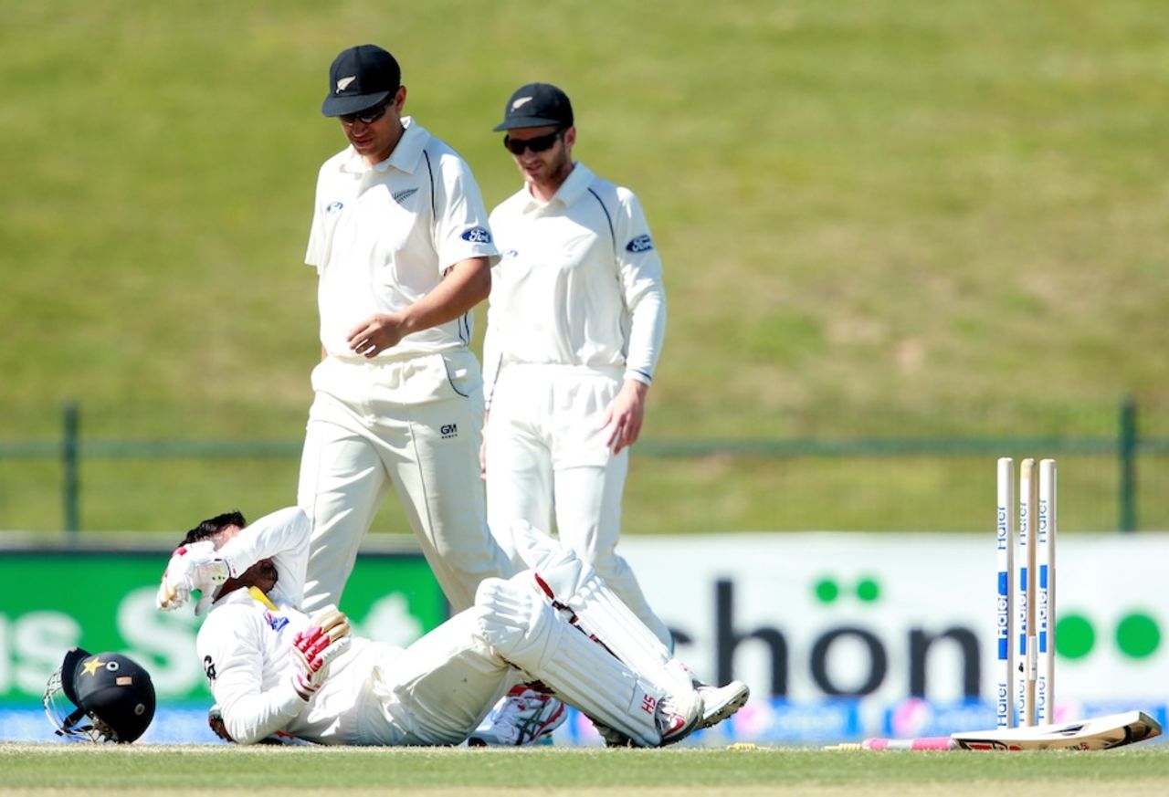 Ahmed Shehzad lies on the ground after getting felled by a bouncer and hitting his wicket, Pakistan v New Zealand, 1st Test, Abu Dhabi, 2nd day, November 10, 2014