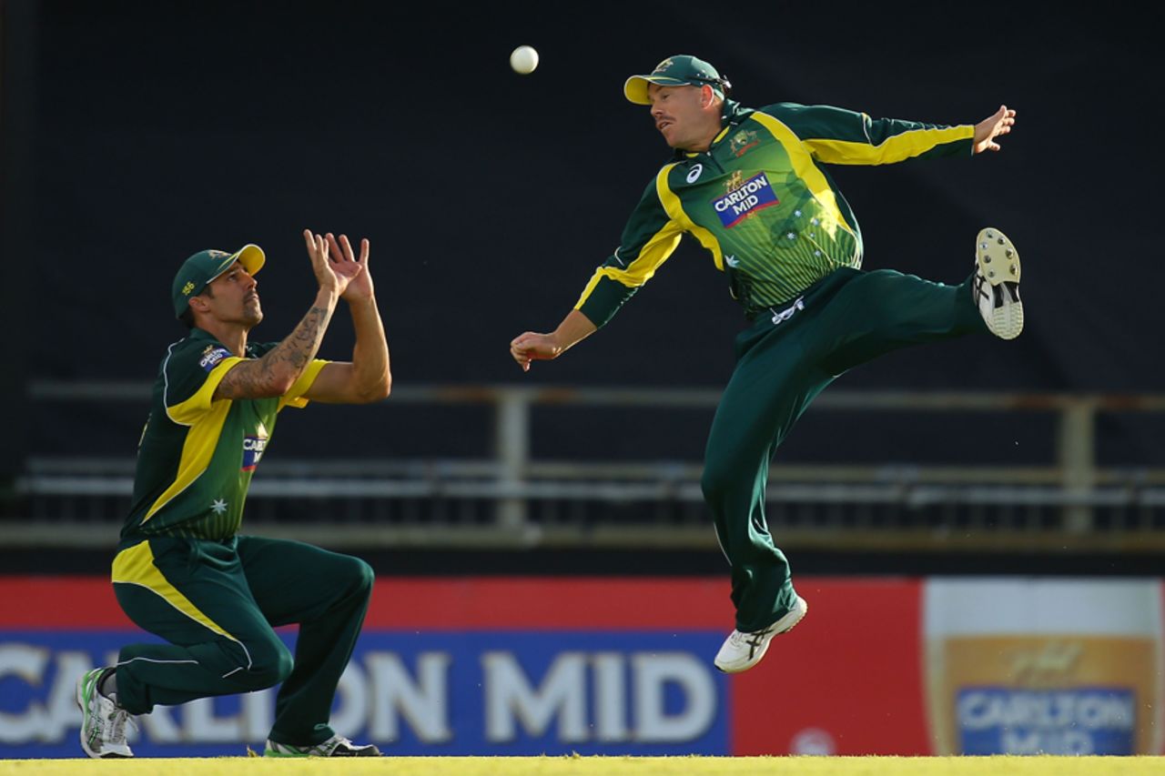 A composed Mitchell Johnson completes a catch despite David Warner diving across him, Australia v South Africa, 2nd ODI, Perth, November 16, 2014