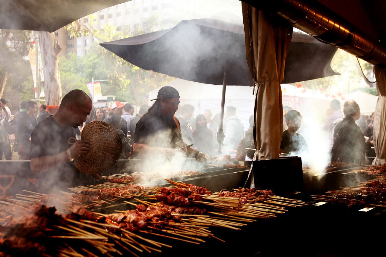 Chefs prepare food at the Sydney Night Noodle Markets at Hyde Park, October 17, 2014