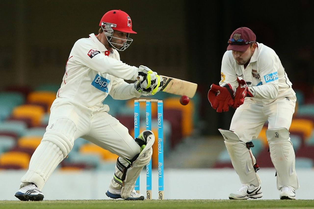 Phillip Hughes cuts in front of Chris Hartley, Queensland v South Australia, Sheffield Shield, Brisbane, 2nd day, October 2, 2012