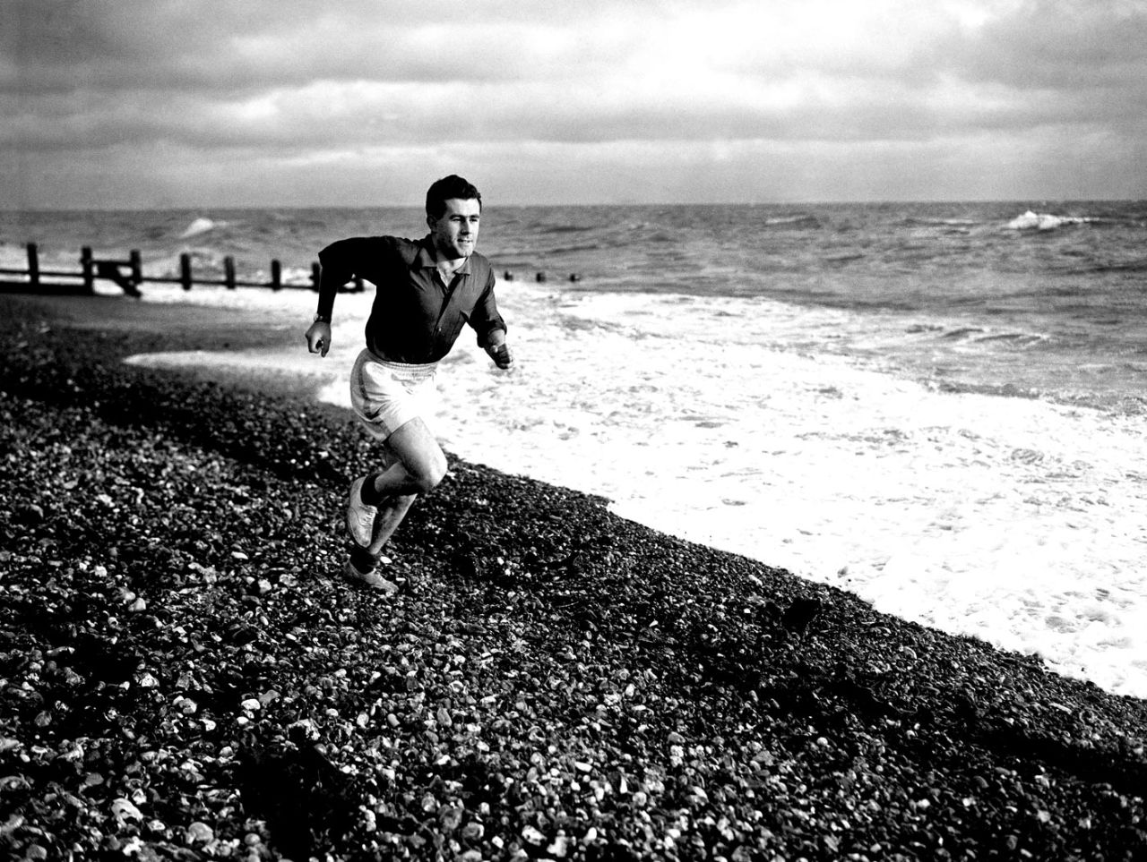 Ken Suttle runs on a shingled beach in Worthing, November 30, 1953