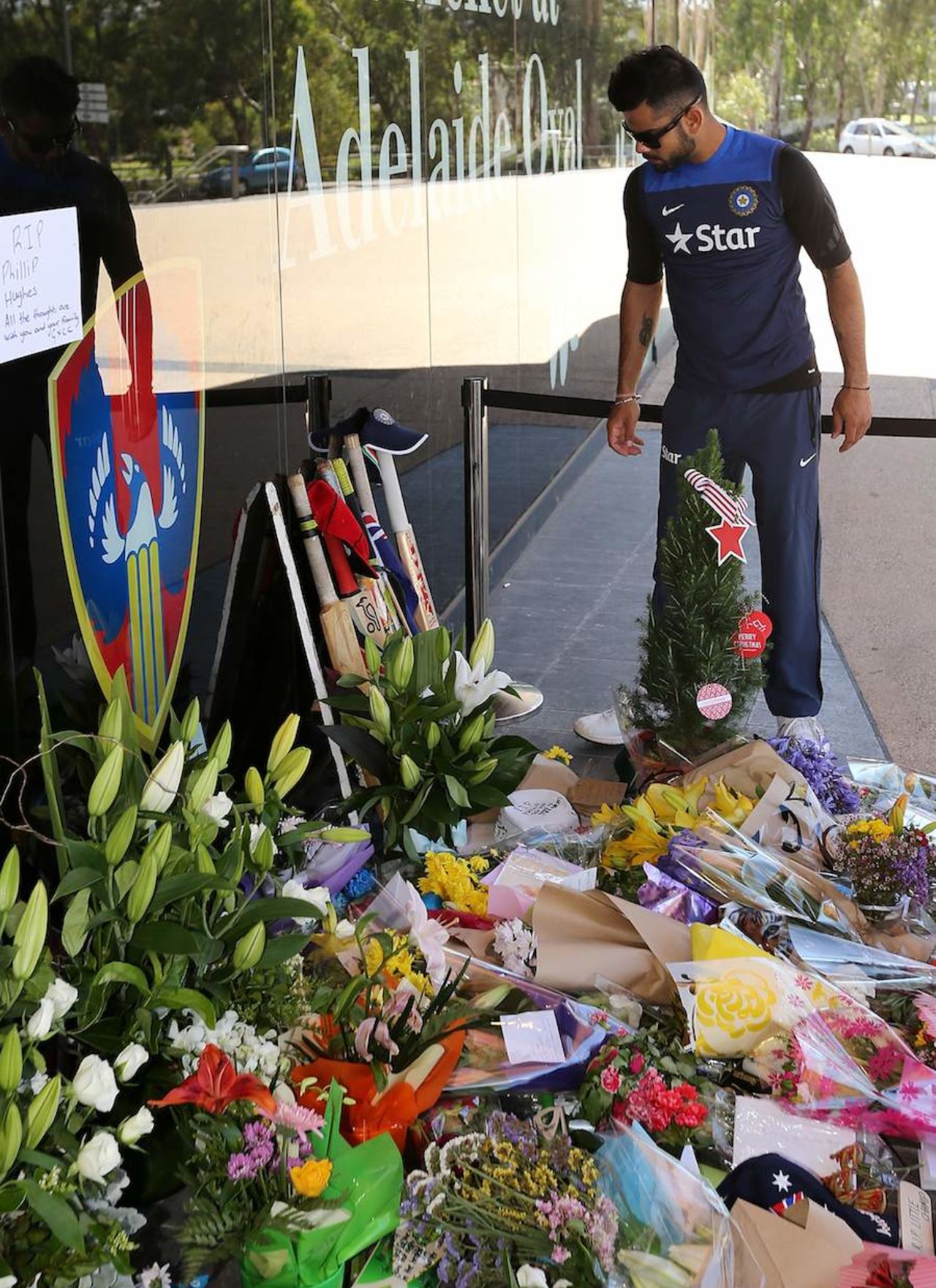 Virat Kohli puts out his bat at a tribute to Phillip Hughes at the Adelaide Oval, Adelaide, November 29, 2014