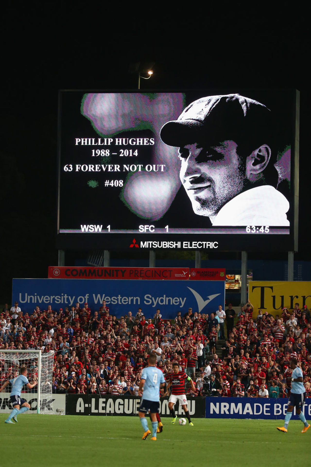 A tribute to Phillip Hughes is seen on the big screen during an A-League match, Sydney, November 29, 2014