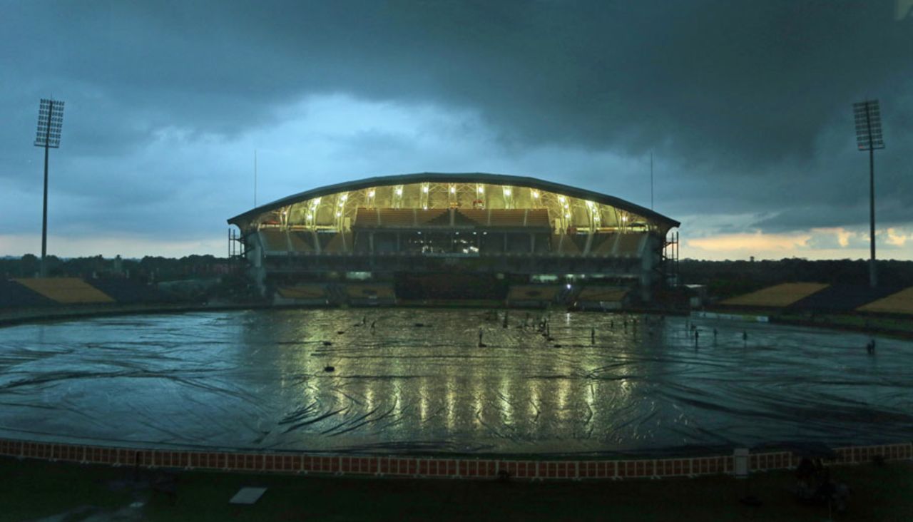 Ground staff cover the field at Hambantota under an overcast sky, Hambantota, December 2, 2014