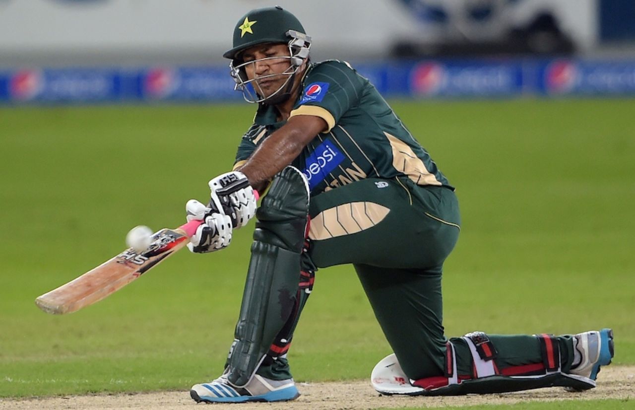 Sarfraz Ahmed goes down for a sweep shot against a seamer, Pakistan v New Zealand, 1st T20, Dubai, December 4, 2014