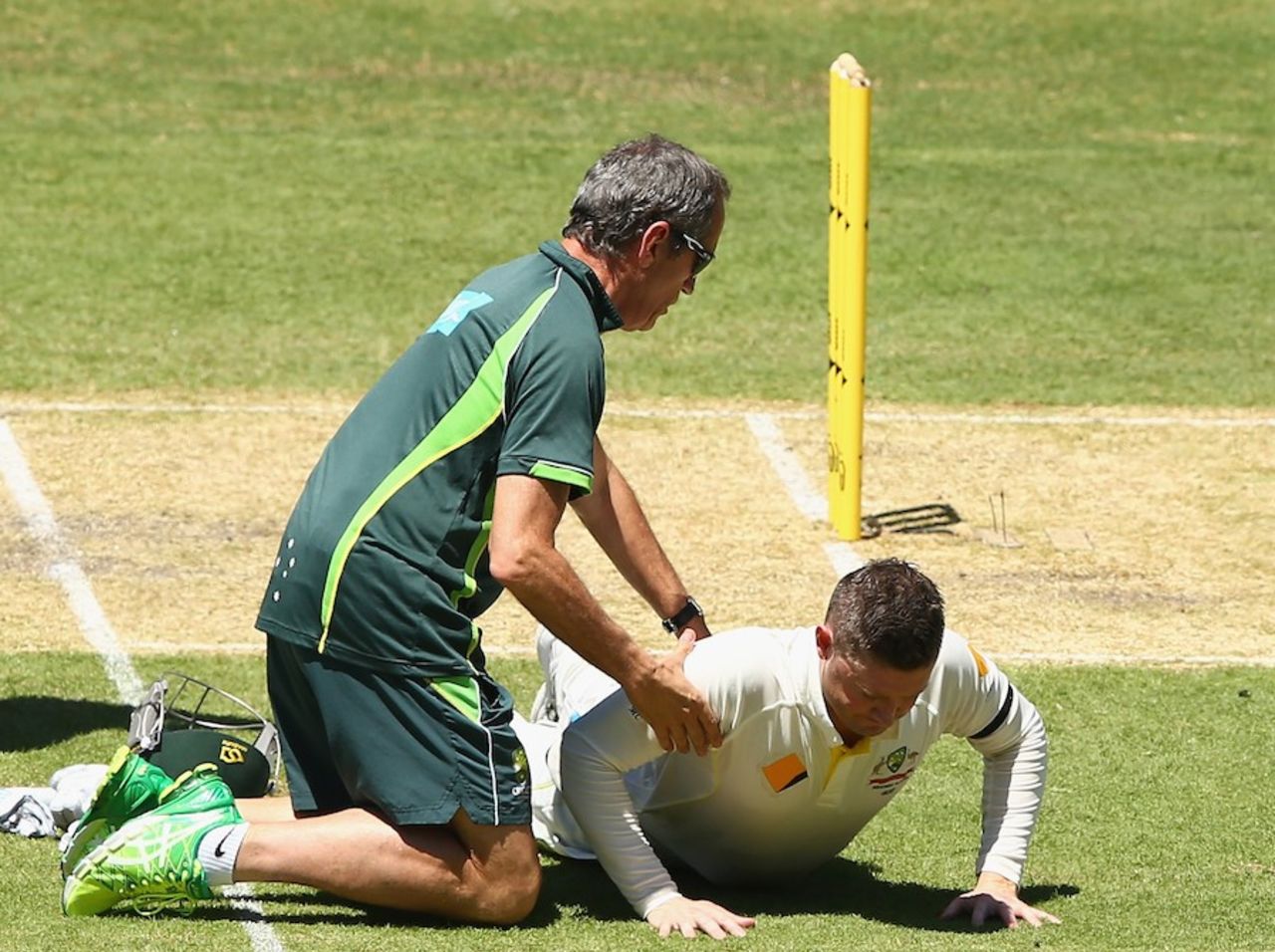 Australia team doctor Peter Brukner checks Michael Clarke's back, Australia v India, 1st Test, Adelaide, 1st day, December 9, 2014
