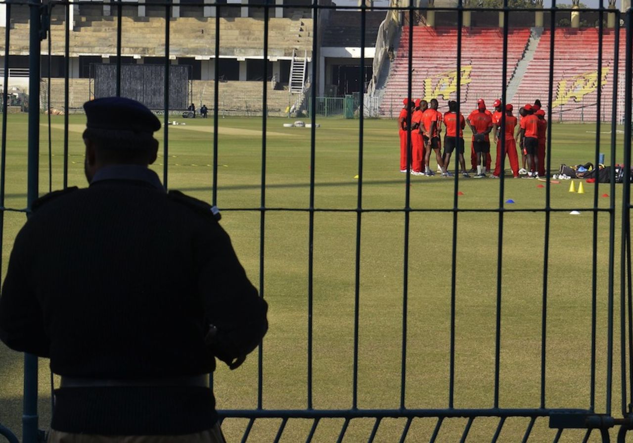 A policeman watches the Kenya team practice at the Gaddafi Stadium, Lahore, December 10, 2014