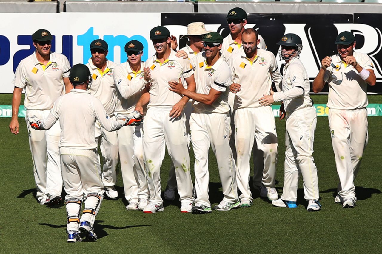Australia gather around Mitch Marsh after he completes the catch to dismiss Virat Kohli, Australia v India, 1st Test, Adelaide, 5th day, December 13, 2014