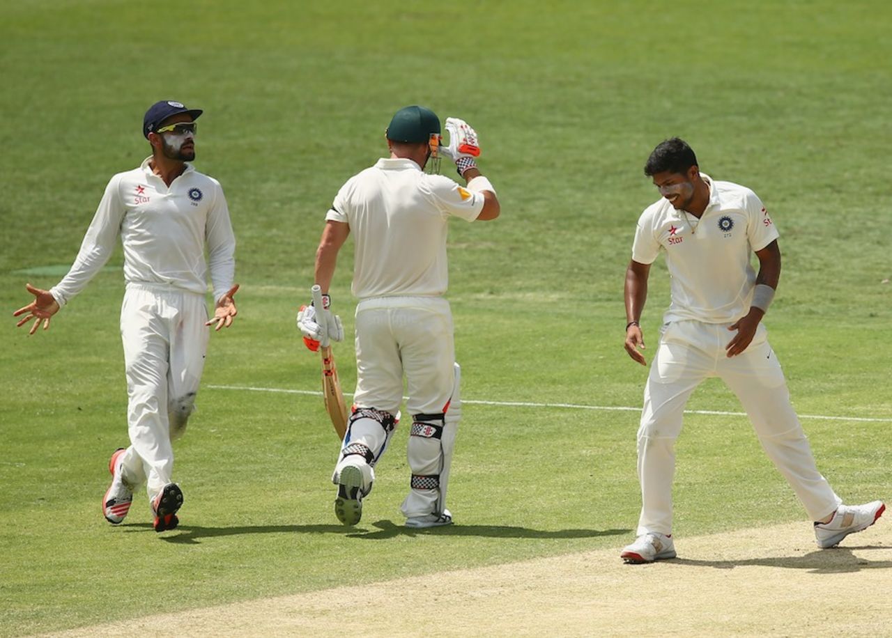 Virat Kohli and Umesh Yadav celebrate David Warner's wicket, Australia v India, 2nd Test, Brisbane, 2nd day, December 18, 2014
