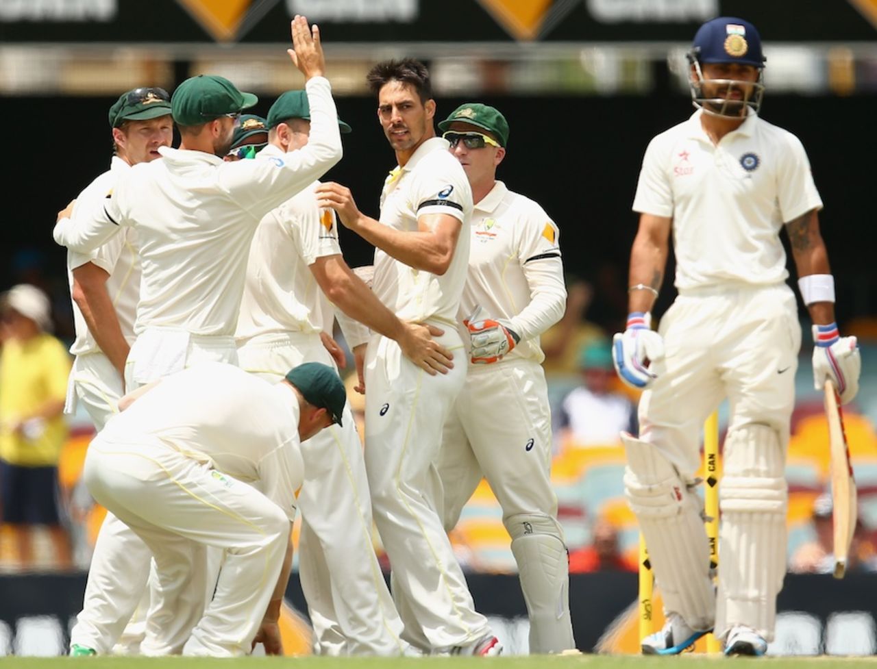 The Australians gather around Mitchell Johnson to celebrate Virat Kohli's wicket, Australia v India, 2nd Test, Brisbane, 4th day, December 20, 2014