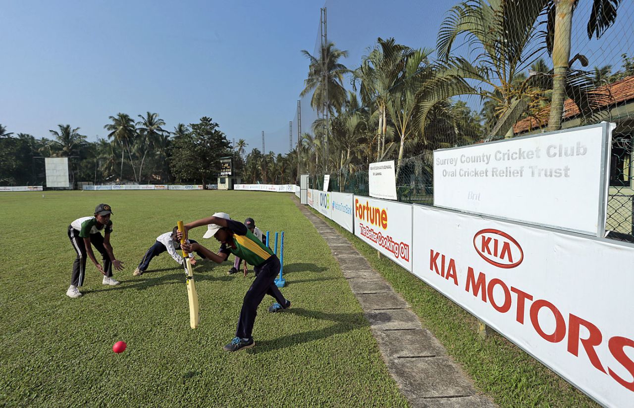 A young batsman practices his drive at the Surrey Village Ground, Maggona, Sri Lanka, December 5, 2014
