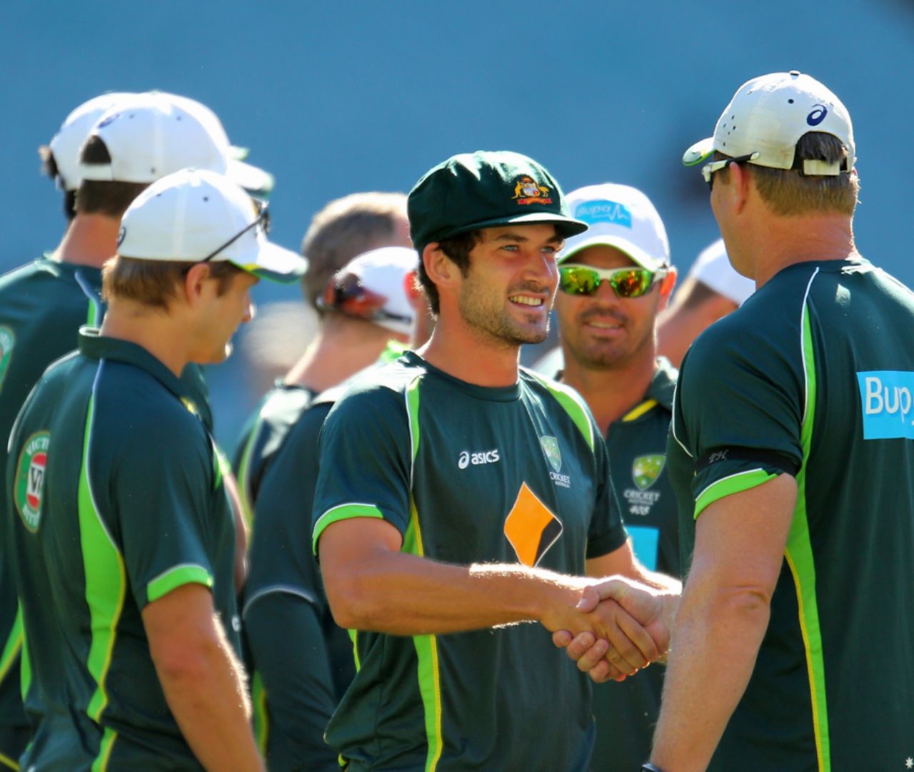 Joe Burns is surrounded by his team-mates after getting his baggy green, Australia v India, 3rd Test, Melbourne, 1st day, December 26, 2014