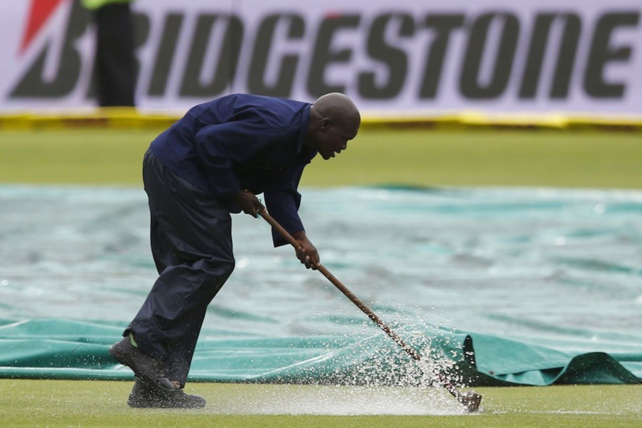 A groundsman works on the wet outfield, South Africa v West Indies, 2nd Test, Port Elizabeth, 2nd day, December 27, 2014
