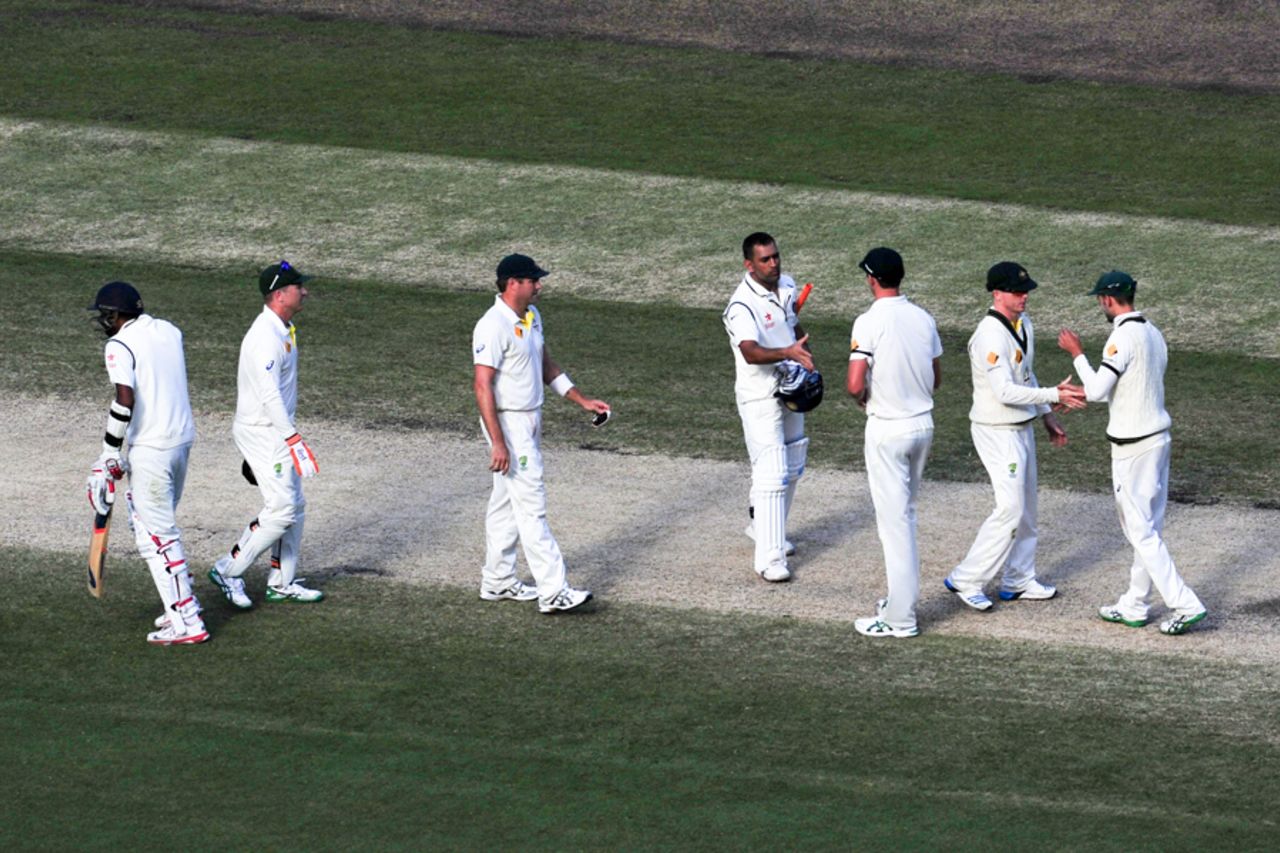 MS Dhoni exchanges handshakes with the Australia team, after what turned out to be his final Test, Australia v India, 3rd Test, Melbourne, 5th day, December 30, 2014