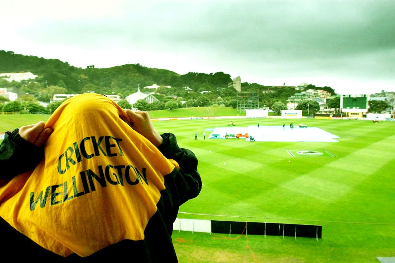 A supporter takes shelter from the elements, New Zealand v England, 2nd Test, Wellington, 1st day, March 21, 2002